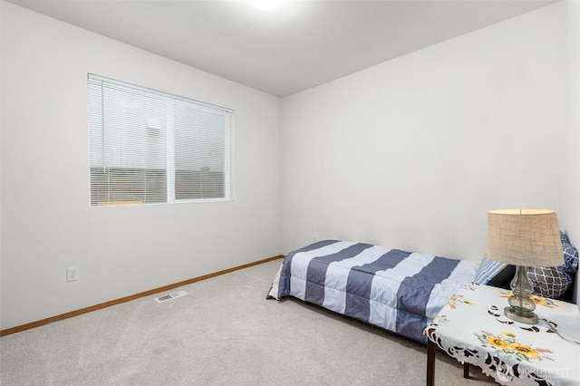 bedroom with carpet flooring, visible vents, and baseboards