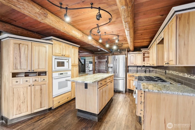 kitchen with white appliances, dark wood-style floors, light stone countertops, a kitchen island, and light brown cabinetry