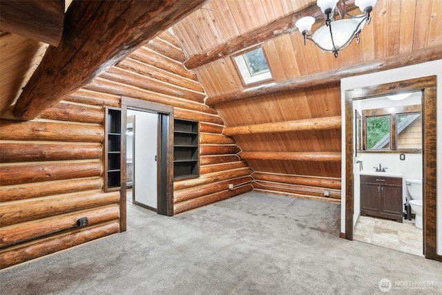 interior space with beam ceiling, a skylight, carpet, and wooden ceiling