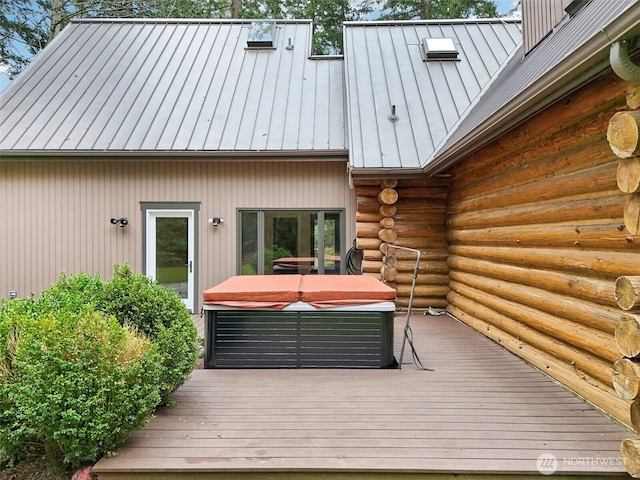 wooden deck featuring a hot tub