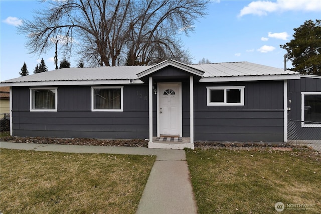 view of front of home with a front yard and metal roof