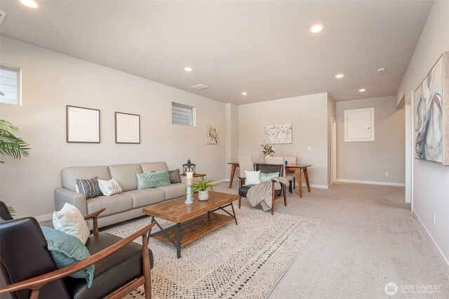 living area with recessed lighting, light colored carpet, and baseboards