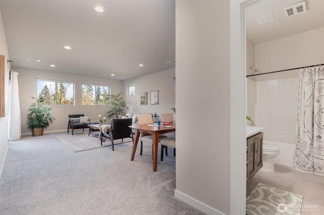 interior space featuring visible vents, recessed lighting, light colored carpet, and baseboards