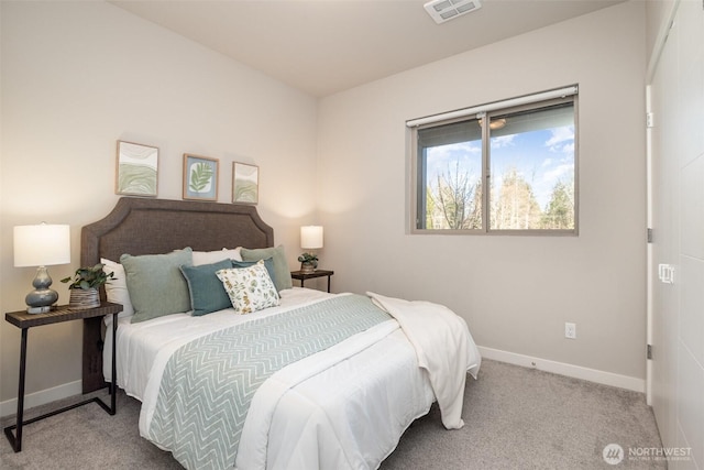 carpeted bedroom featuring baseboards and visible vents