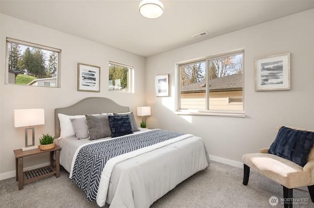 bedroom with visible vents, carpet floors, and baseboards