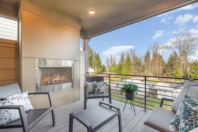 balcony with a lit fireplace