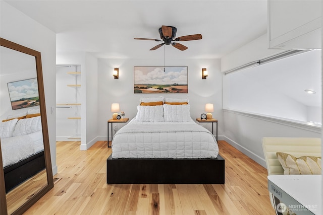 bedroom with baseboards and light wood finished floors