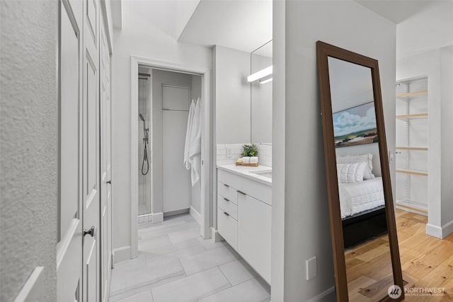 bathroom with a stall shower and vanity