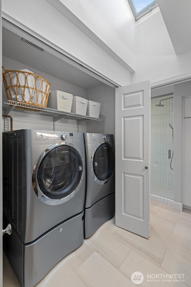 laundry area featuring washer and clothes dryer and laundry area