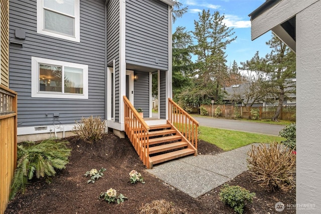 view of exterior entry with fence