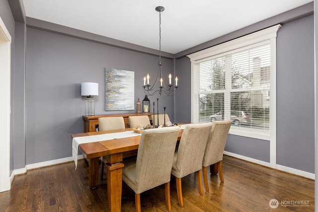 dining room featuring an inviting chandelier, wood finished floors, and baseboards