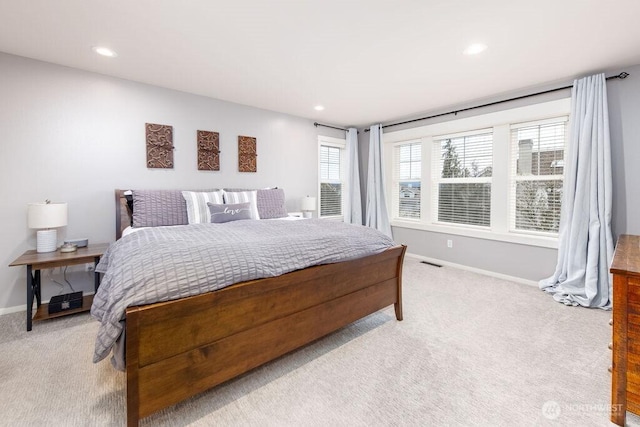 bedroom featuring recessed lighting, visible vents, light colored carpet, and baseboards