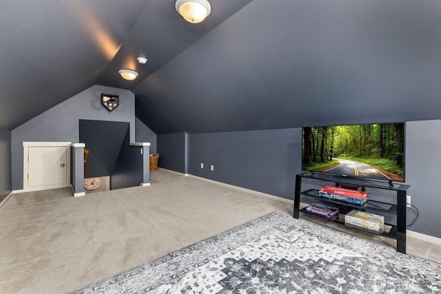 interior space with baseboards, carpet, and vaulted ceiling