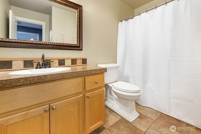 full bath featuring tile patterned floors, curtained shower, toilet, and vanity