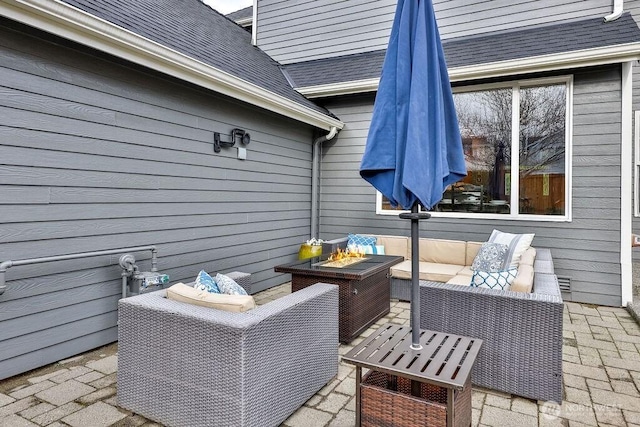 view of patio / terrace with an outdoor living space with a fire pit