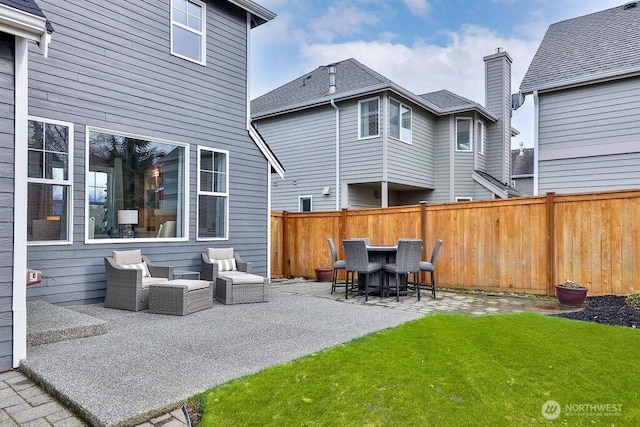 back of house featuring a patio, a yard, and fence