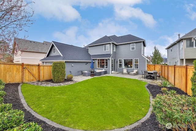 back of property with a gate, a yard, a fenced backyard, and a patio area