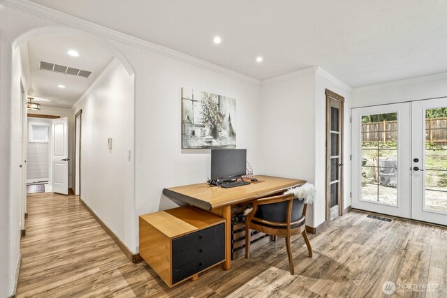 office featuring french doors, arched walkways, visible vents, and wood finished floors