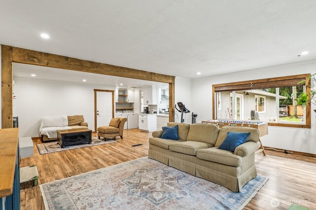 living area with recessed lighting and light wood-style floors