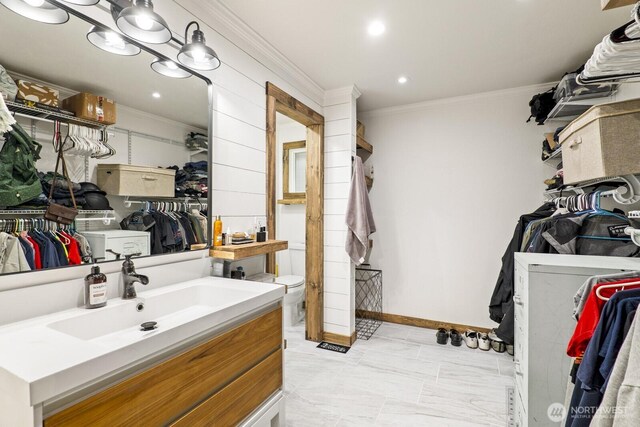 bathroom with vanity, baseboards, recessed lighting, ornamental molding, and toilet