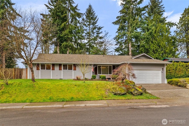 ranch-style home featuring an attached garage, driveway, a front yard, and fence