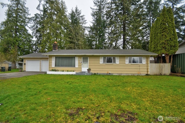 ranch-style home with a front yard, fence, driveway, an attached garage, and a chimney