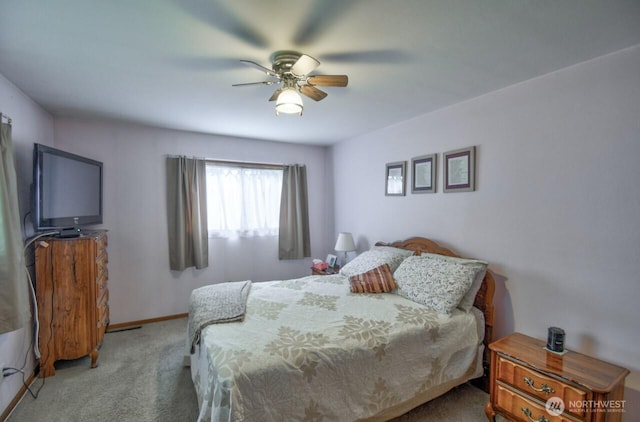 carpeted bedroom featuring baseboards and a ceiling fan