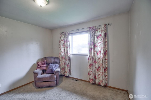 sitting room with visible vents, baseboards, and carpet