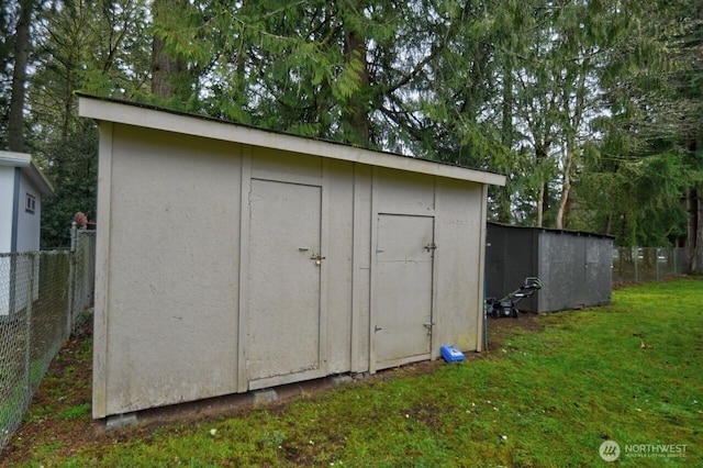 view of shed featuring fence