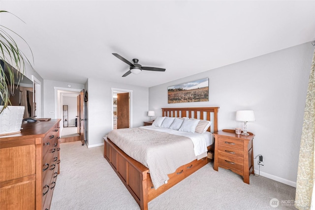 bedroom with light colored carpet, baseboards, and ceiling fan