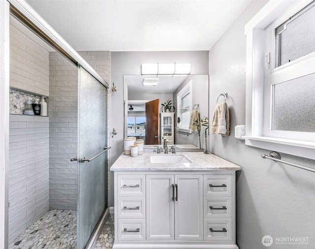 full bathroom with a stall shower and vanity