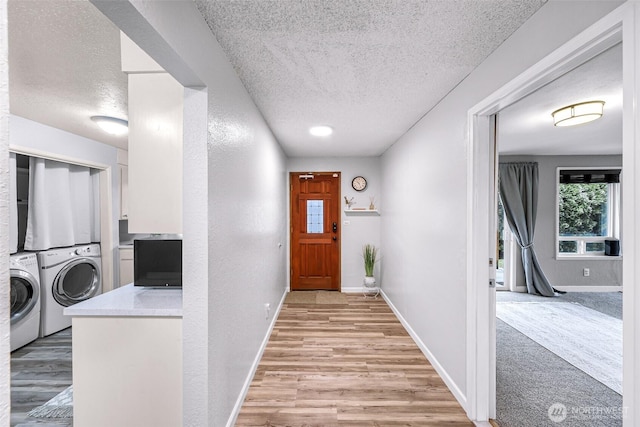 hallway featuring baseboards and light wood finished floors