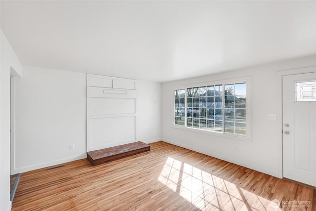 entrance foyer with visible vents, light wood-style flooring, and baseboards