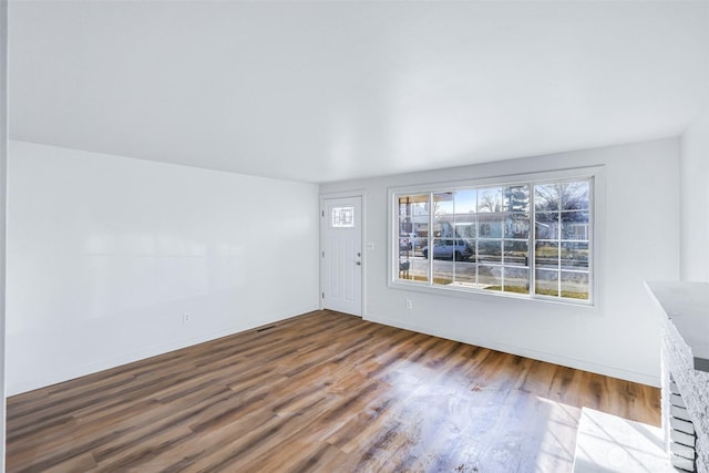 entrance foyer featuring baseboards and wood finished floors