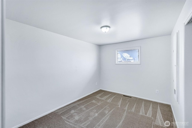 unfurnished room featuring visible vents, baseboards, and carpet floors