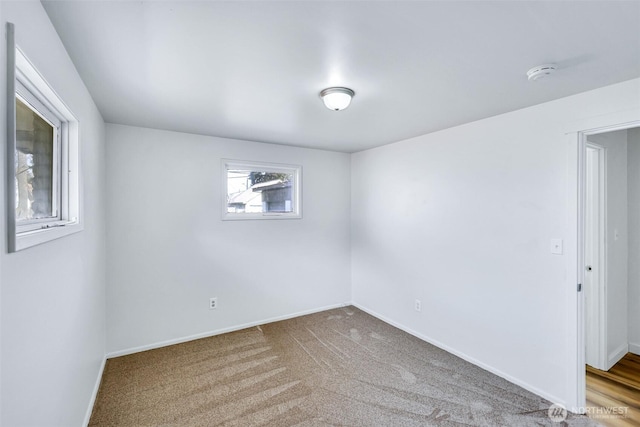 empty room with baseboards and carpet floors