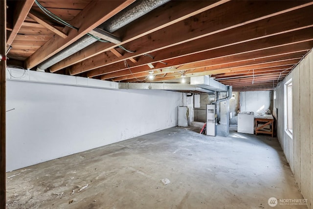 unfinished basement featuring washer / dryer