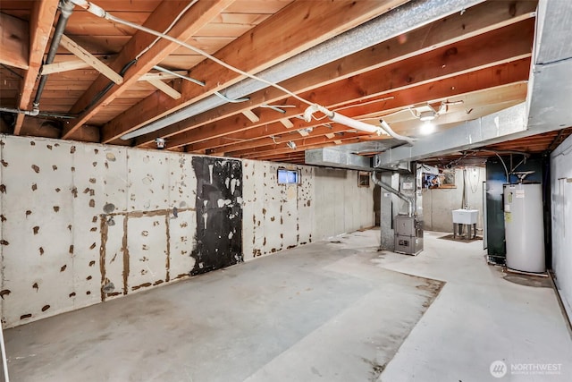 unfinished below grade area featuring a sink, heating unit, and water heater