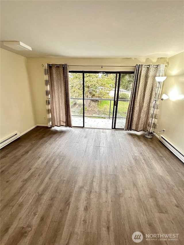 unfurnished living room with a baseboard radiator, baseboards, and wood finished floors