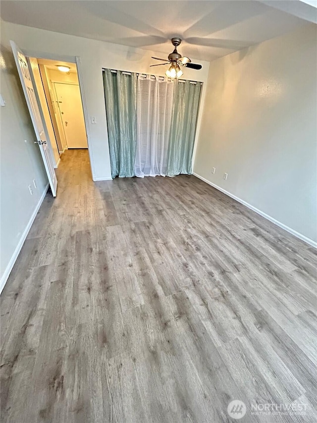 unfurnished bedroom with baseboards and wood finished floors