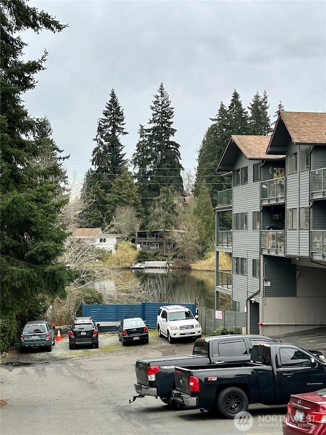 view of parking / parking lot featuring a water view