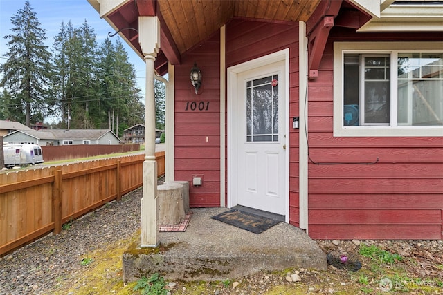 doorway to property featuring fence