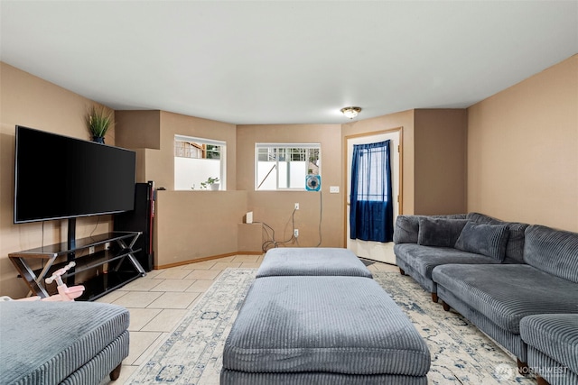 living room with light tile patterned flooring and baseboards