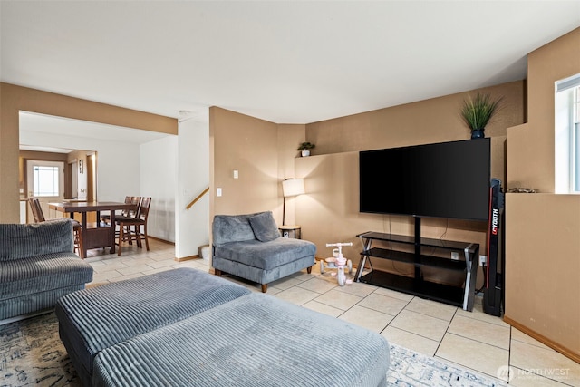 tiled living area with stairs and baseboards