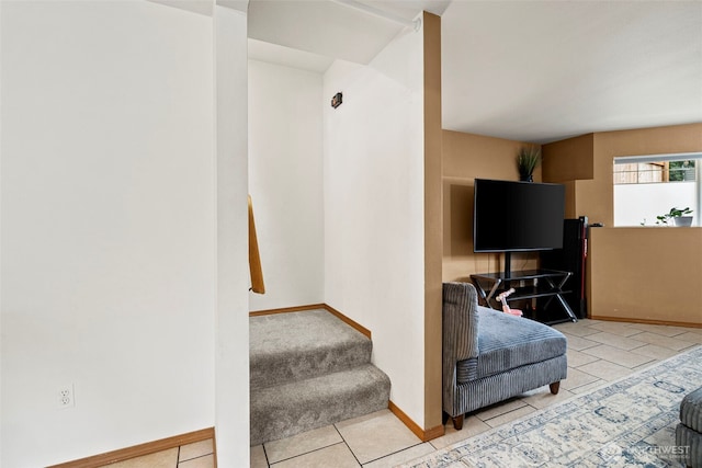 tiled living room with stairs and baseboards