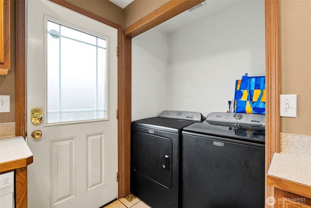 clothes washing area featuring laundry area, visible vents, and independent washer and dryer