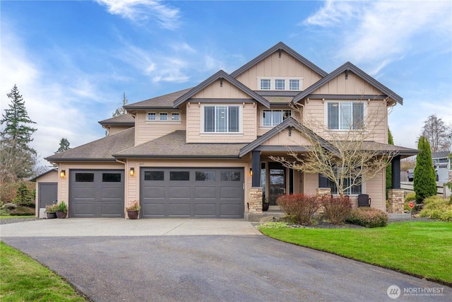 craftsman house featuring aphalt driveway, a porch, board and batten siding, a front yard, and a shingled roof