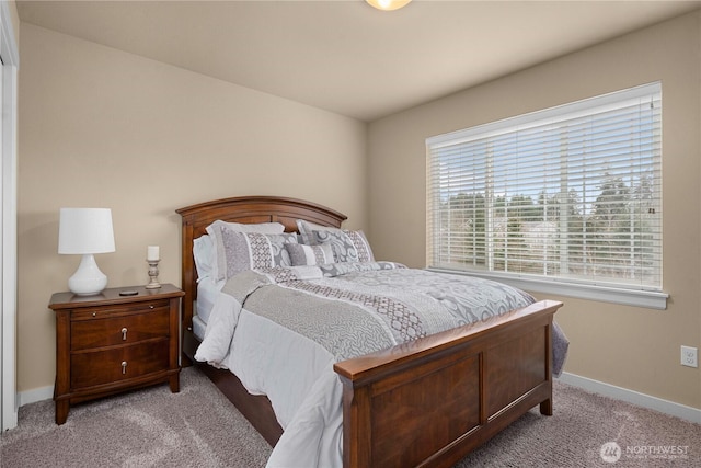 bedroom with baseboards and light colored carpet