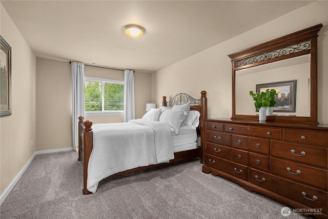 carpeted bedroom featuring baseboards