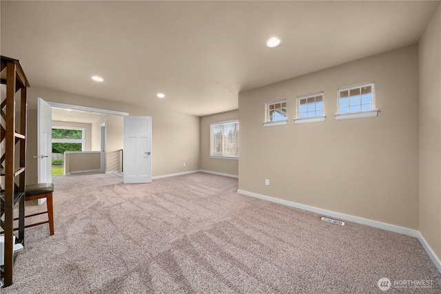 empty room with light carpet, visible vents, recessed lighting, and baseboards